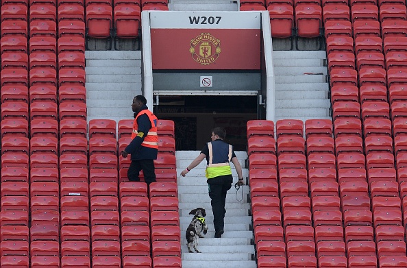 Sniffer dogs in the stands at Old Trafford | Photo: Oli Scarff/AFP