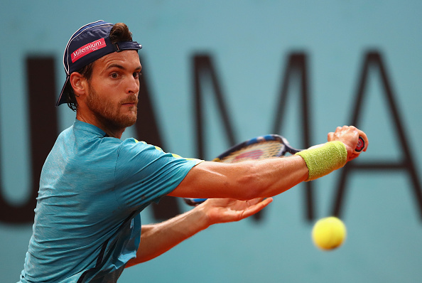 Joao Sousa reaches for a backhand during his round of 16 win. Photo: Clive Brunskill/Getty Images