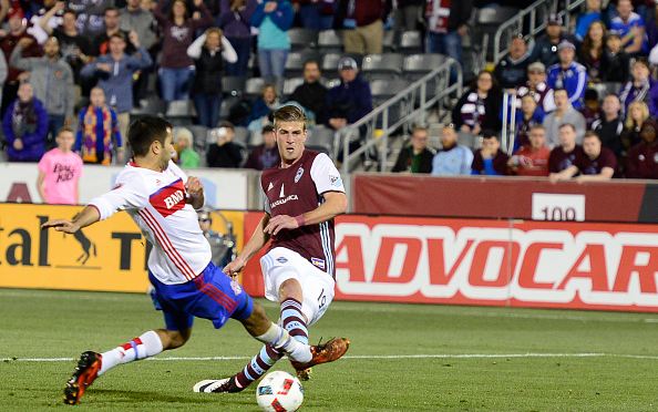 Steven Beitashour (left, in white) blocks a shot against the Colorado Rapids on April 2, 2016. Photo credit: Brent Lewis/Denver Post 