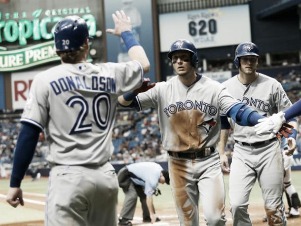 Josh Donaldson greets Troy Tulowitzki at home plate after he rounds on the bases. (Brian Blanco/Getty Images)