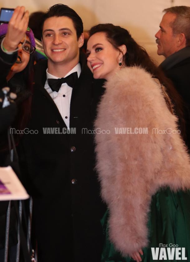 Selfie, anyone? Canadian sweethearts Tessa Virtue and Scott Moir pose for a picture with a fan on the red carpet, with astronaut Chris Hadfield trailing not too far behind them.