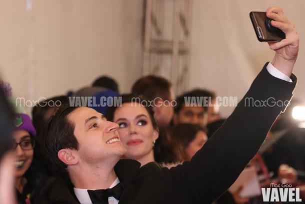 Say cheese! Scott Moir poses for a selfie with a fan on the red carpet.