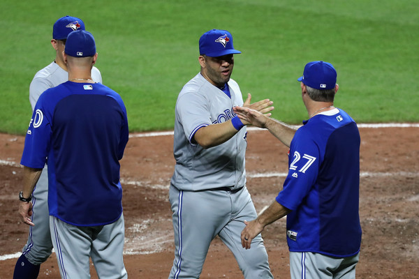 Kendrys Morales celebrates with Blue Jays quality control coach Derek Shelton after the game. | Photo: Rob Carr/Getty Images