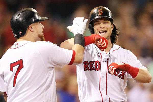 Andrew Benintendi celebrates with Christian Vazquez after hitting a solo home run in the eighth to make it a one-run game against the Blue Jays. | Photo: Adam Glanzman/Getty Images