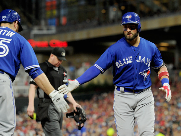 Kevin Pillar high fives Russell Martin after scoring a run earlier in the game. | Photo: Hannah Foslien/Getty Images
