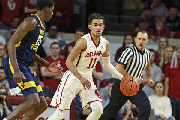 Young drives past West Virginia's Lamont West during Oklahoma's loss/Photo: Brett Deering/Getty Images