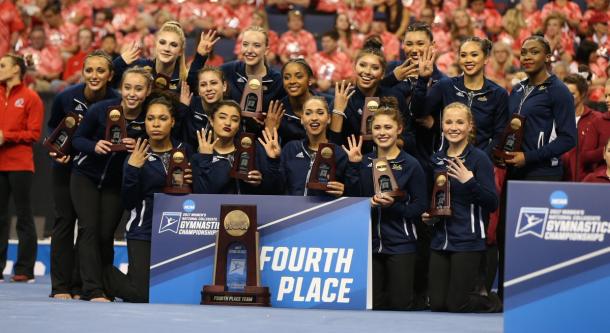 UCLA Gymnastics receives the fourth place trophy. Photo Credit: UCLA Gymnastics Twitter.