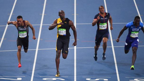 This is about the time that Usain Bolt realized he had the race in the bag, celebrating early by pumping his chest like always. Photo Credit: Jack Gruber/USA TODAY. 