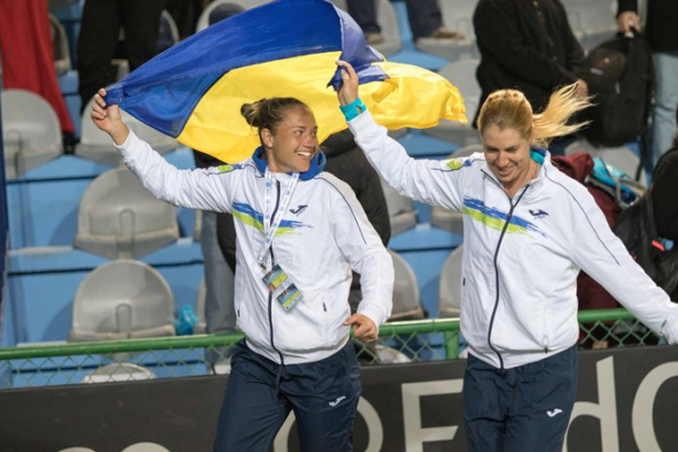 Bondarenko and Savchuk wave the flag after Ukraine's victory. Photo: Fed Cup