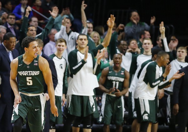 Bryn Forbes #5 of the Michigan State Spartans reacts after scoring a three-point basket as the bench cheers against the Rutgers Scarlet Knights during the second half of a college basketball game at the Rutgers Athletic Center on March 2, 2016 in Piscataway, New Jersey. Michigan State defeated Rutgers 97-66. (March 2, 2016 - Source: Rich Schultz/Getty Images North America) 