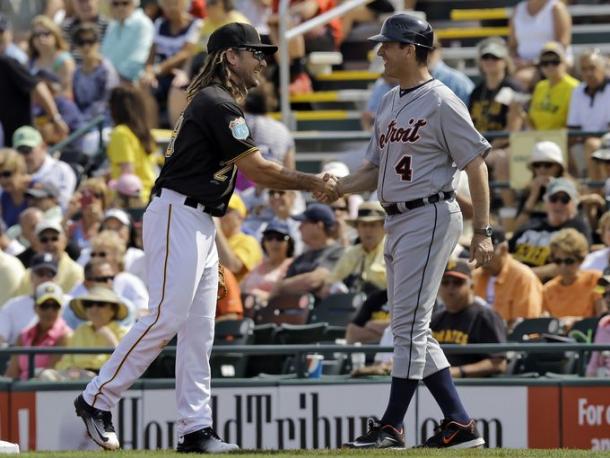 Michigan football coach Jim Harbaugh (4) shakes hands with Pittsburgh Pirates first baseman John Jaso during the first inning of a spring training baseball game between the Pirates and the Detroit Tigers. (Chris O'Meara, Associated Press)