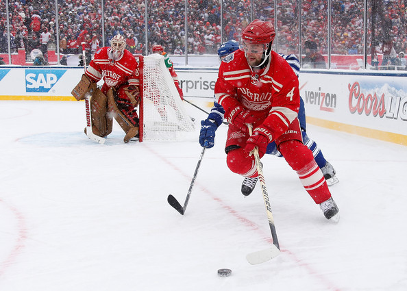 Jakub Kindl #4 of the Detroit Red Wings heads up ice as Nikolai Kulemin #41 of the Toronto Maple Leafs gives chase during the 2014 Bridgestone NHL Winter Classic. (Dec. 31, 2013 - Source: Gregory Shamus/Getty Images North America)