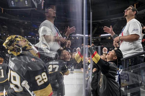 Marc Andre-Fluery tosses a puck to fan Zachary Gray at T-Mobile Arena. (Photo: Benjamin Hager - Las Vegas Review-Journal)