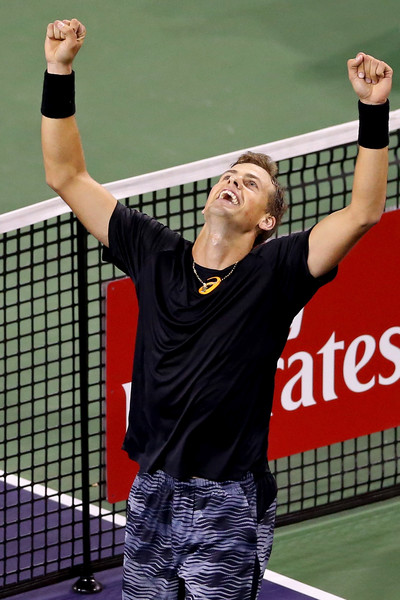 Vasek Pospisil raises his arms up in celebration after defeating Andy Murray in the second round of the 2017 BNP Paribas Open. | Photo: Matthew Stockman/Getty Images