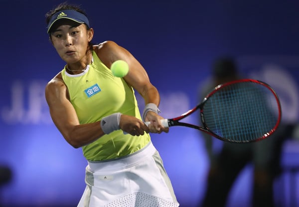 Photo Source: Francois Nel/Getty Images Europe- Qiang Wang hits a backhand shot.