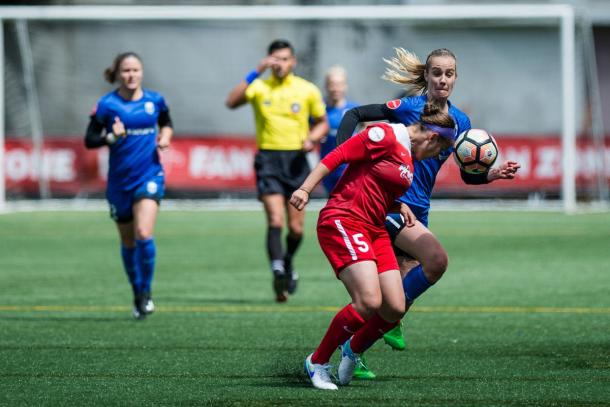 Church going for the ball against Seattle Reign forward Beverly Yanez | Source: Jane Gershovich