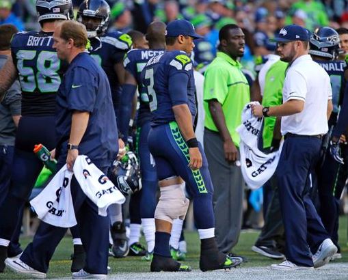 Russell Wilson seen here on the sidelines with ice wrapped around his knee | Source: Ted S. Warren - AP 