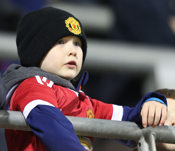 A young United fan watches on | Photo: John Peters/Manchester United