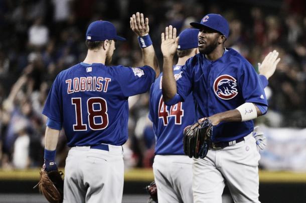 Ben Zobrist and Dexter Fowler high five each other after defeating the Arizona Diamondbacks (AP Photo)