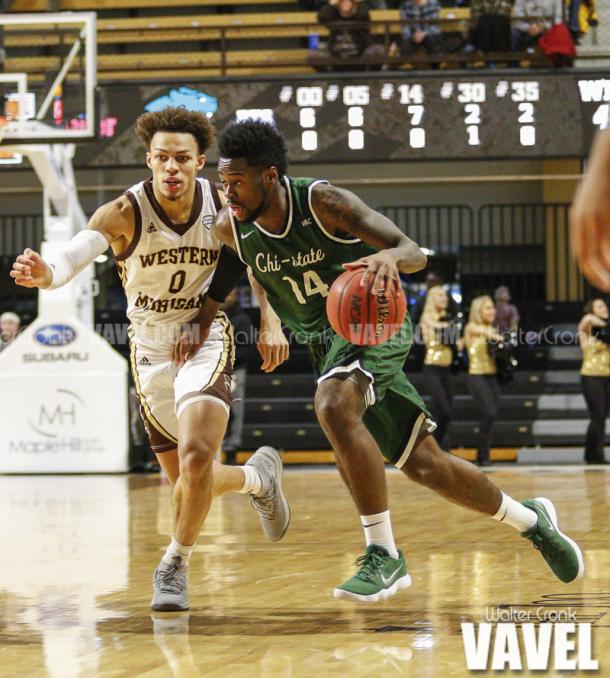 Fred Sims Jr. (14) tries to get around Bryce Moore (0) to the basket. Photo: Walter Cronk