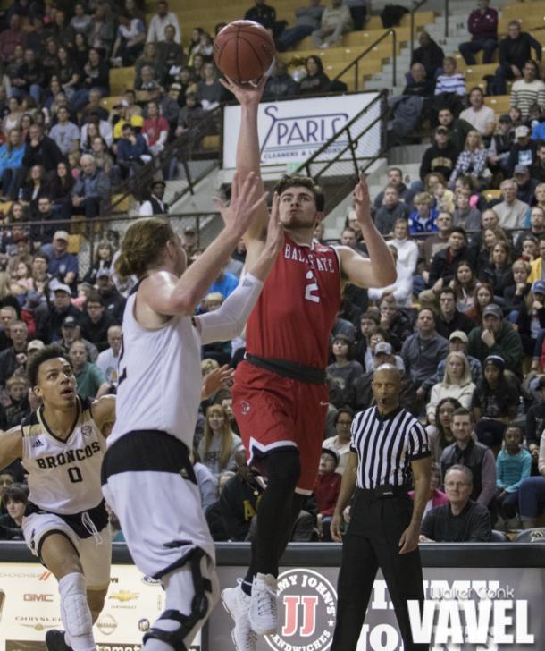 Tayler Persons (2) takes the one handed shot over Drake LaMont (42). Photo: Walter Cronk