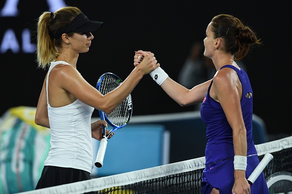 Radwanska and Pironkova shake hands at the net (Photo by Greg Wood / Getty Images)