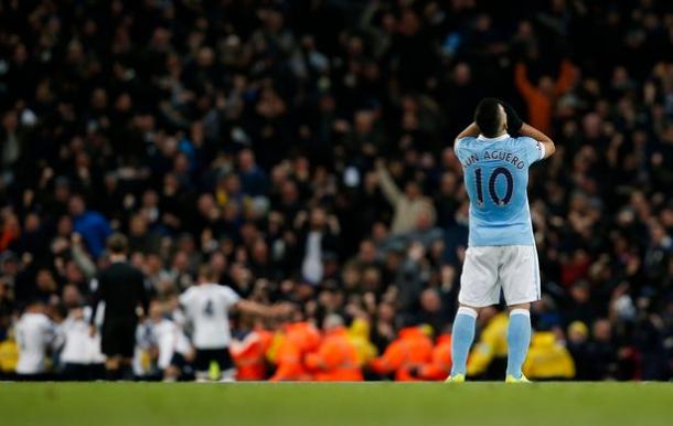 Aguero's pose evidences City's recent form, as Spurs players run off into the sunset (photo: reuters)