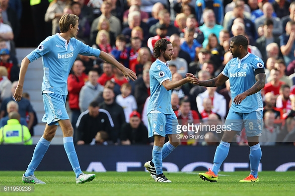 Joe Allen celebrates scoring his sides first goal with his team mate Glen Johnson during the Premier League match between Manchester United and Stoke City at Old Trafford. | Photo: Clive Brunskill/Getty Images