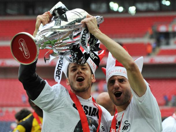 Rangel (right) celebrates with Andrea Orlandi (left) after winning promotion to the Premier League. (Photo: Swansea City AFC)