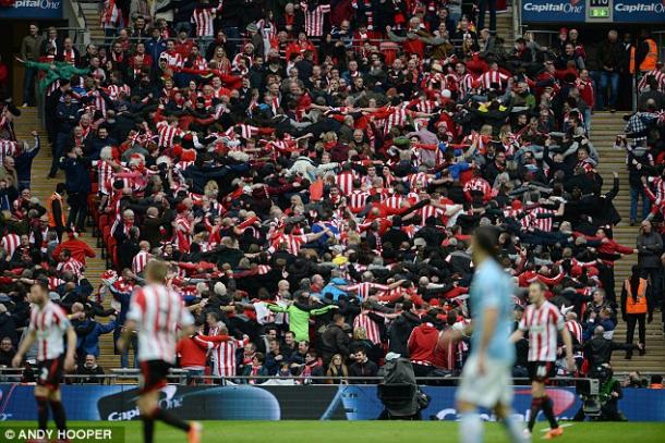 Above: Sunderland fans in celebration during their 3-1 defeat to Manchester City in the 2014 League Cup final 