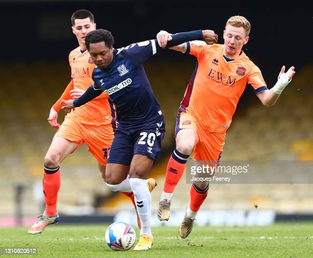 Ashley Nathaniel-George of Southend United battles for possession with Callum Guy of Carlisle United during the Sky Bet League Two match between Southend United and Carlisle United at Roots Hall on April 03, 2021 in Southend, England. Sporting stadiums around the UK remain under strict restrictions due to the Coronavirus Pandemic as Government social distancing laws prohibit fans inside venues resulting in games being played behind closed doors. (Photo by Jacques Feeney/Getty Images)