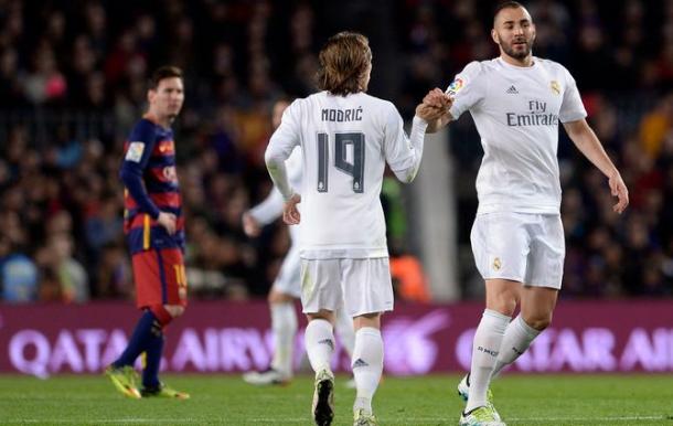 Benzema celebrates a goal on Saturday with Messi, who was kept out, looks on (photo: getty)