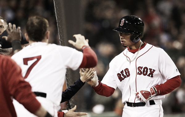 Mookie Betts gets greeted in the Red Sox dugout after scoring in the fourth inning. (Photo:Adam Glanzman/Getty Images North America