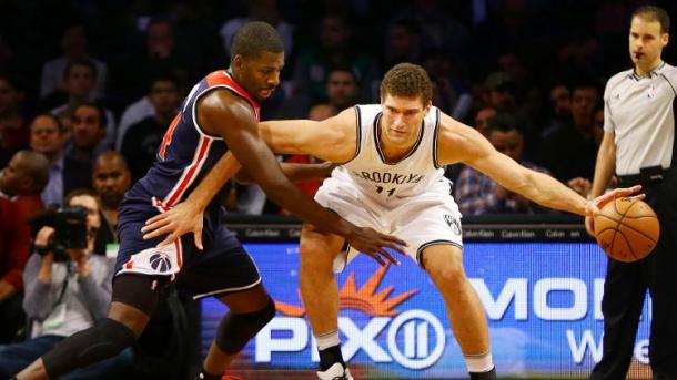 Forward Andrew Nicholson defending against Nets Center Brook Lopez. Photo by Andy Marlin/USA Today Sports Images.