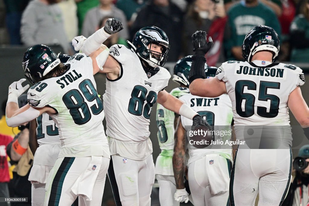 Dallas Goedert #88 of the Philadelphia Eagles celebrates with Jack Stoll #89 and Lane Johnson #65 after scoring a touchdown against the <strong><a  data-cke-saved-href='https://www.vavel.com/en-us/mlb/2023/10/04/1158066-american-league-wild-card-series-game-1-montgomery-leads-rangers-past-sloppy-rays.html' href='https://www.vavel.com/en-us/mlb/2023/10/04/1158066-american-league-wild-card-series-game-1-montgomery-leads-rangers-past-sloppy-rays.html'>Tampa Bay</a></strong> Buccaneers during the second quarter in the NFC Wild Card Playoffs at Raymond James Stadium on January 15, 2024 in Tampa, Florida. (Photo by Julio Aguilar/Getty Images)
