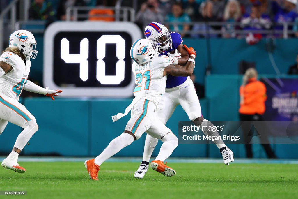 DeShon Elliott #21 of the Miami Dolphins tackles Leonard Fournette #5 of the Buffalo Bills during the first quarter at Hard Rock Stadium on January 07, 2024 in Miami Gardens, Florida. (Photo by Megan Briggs/Getty Images)