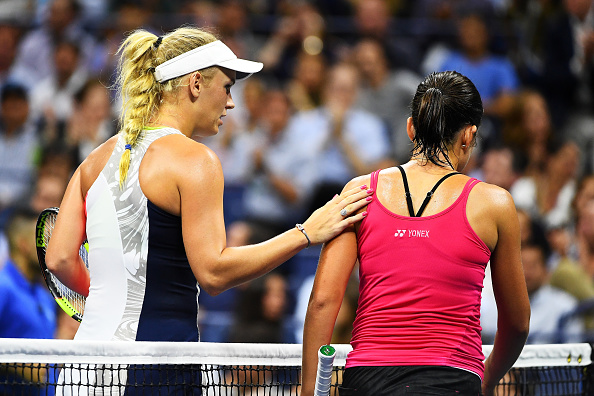Wozniacki consoles Sevastova at the net (Photo by Alex Goodlett / Getty Images)