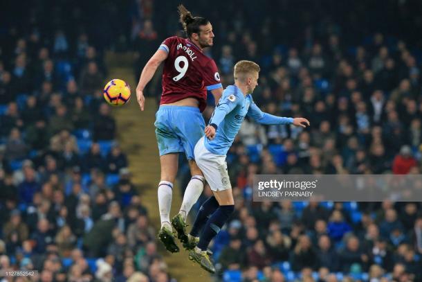 Caroll battles with Oleksandr Zinchenko of Manchester City at the Etihad Stadium back in February (Photo by Lindsey Parnaby/Getty Images)