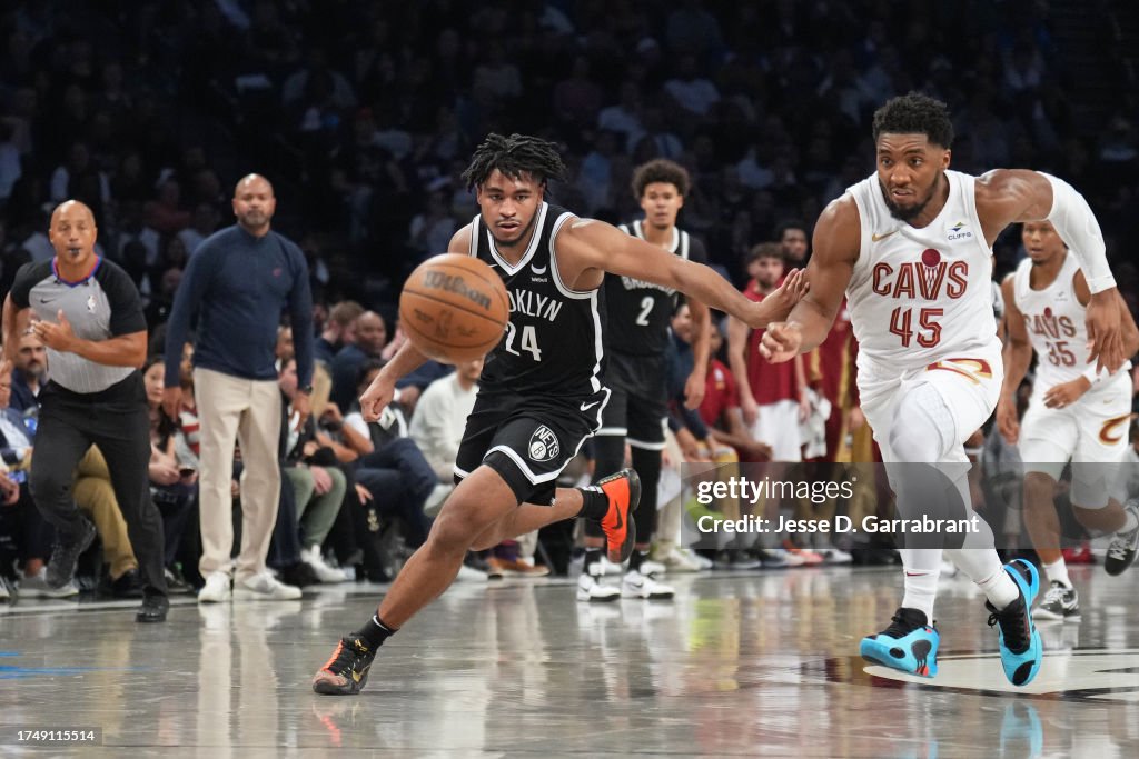 Cam Thomas #24 of the Brooklyn Nets and Donovan Mitchell #45 of the Cleveland Cavaliers go for loose ball during the game on October 25, 2023 at Barclays Center in Brooklyn, New York. NOTE TO USER: User expressly acknowledges and agrees that, by downloading and or using this Photograph, user is consenting to the terms and conditions of the Getty Images License Agreement. Mandatory Copyright Notice: Copyright 2023 NBAE (Photo by Jesse D. Garrabrant/NBAE via Getty Images)
