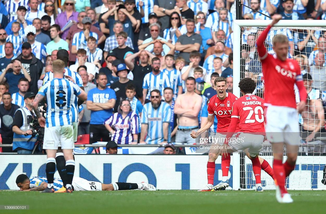 <strong><a  data-cke-saved-href='https://www.vavel.com/en/football/2022/03/20/1105851-nottingham-forest-0-1-liverpool-jota-goal-edges-reds-into-fa-cup-semi-final.html' href='https://www.vavel.com/en/football/2022/03/20/1105851-nottingham-forest-0-1-liverpool-jota-goal-edges-reds-into-fa-cup-semi-final.html'>Nottingham Forest</a></strong> celebrate taking the lead in front of the <strong><a  data-cke-saved-href='https://www.vavel.com/en/football/2022/05/16/championship/1111888-huddersfield-town-vs-luton-town-preview-how-to-watch-team-news-predicted-lineups-kick-off-time-and-ones-to-watch.html' href='https://www.vavel.com/en/football/2022/05/16/championship/1111888-huddersfield-town-vs-luton-town-preview-how-to-watch-team-news-predicted-lineups-kick-off-time-and-ones-to-watch.html'>Huddersfield Town</a></strong> supporters: Christopher Lee/GettyImages