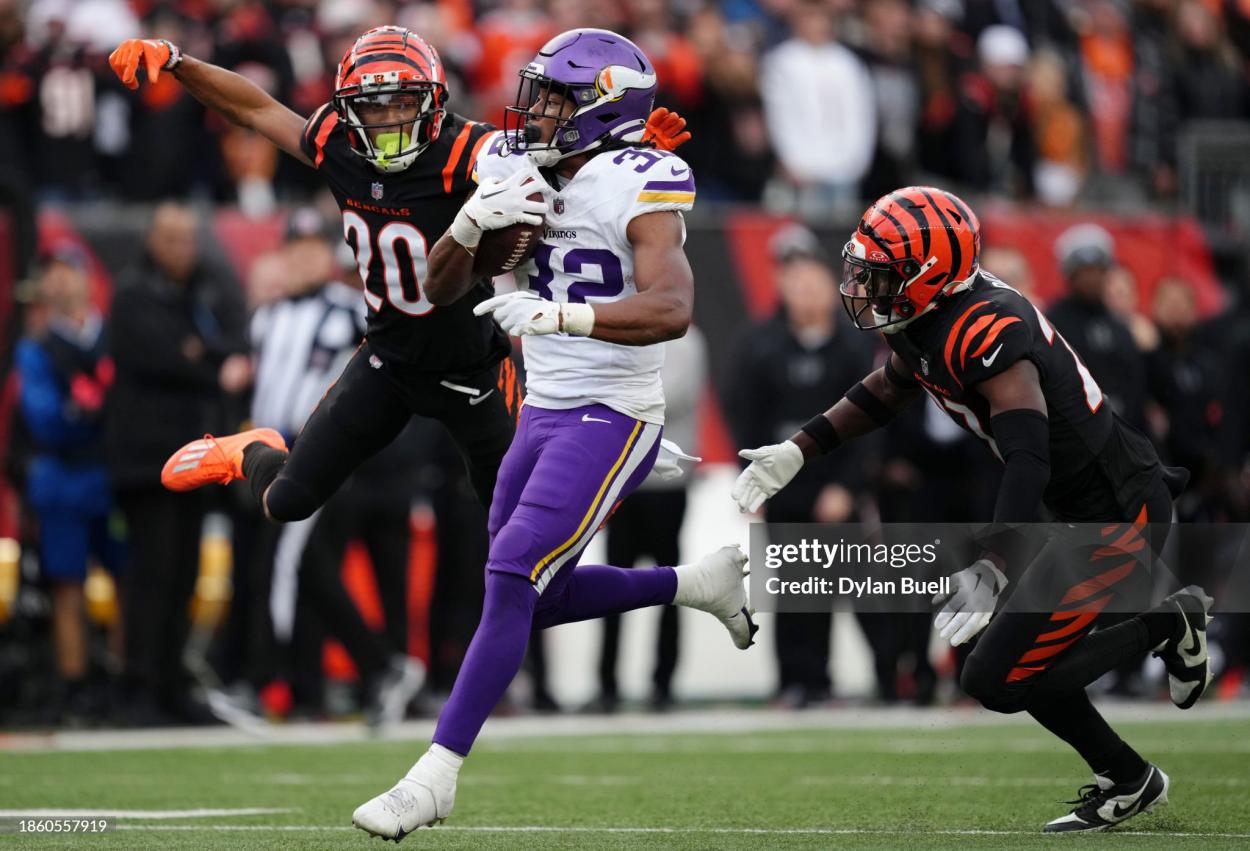 Ty Chandler #32 of the Minnesota Vikings carries the ball in the fourth quarter of the game against the Cincinnati Bengals at Paycor Stadium on December 16, 2023 in Cincinnati, Ohio. (Photo by Dylan Buell/Getty Images) Minnesota Vikings v Cincinnati Bengals