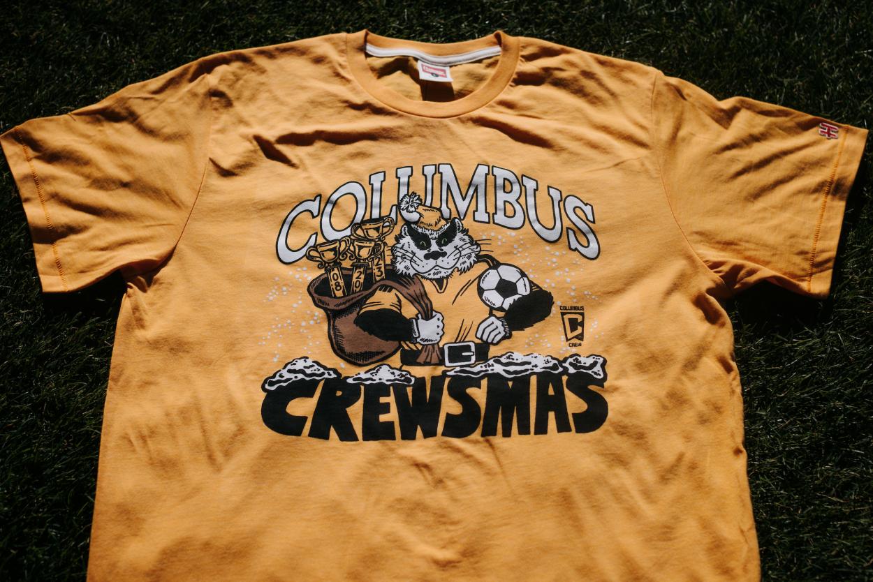 Crewsmas t-shirt. photo Courtesy of <strong><a  data-cke-saved-href='https://www.vavel.com/en-us/soccer/2023/11/25/mls/1164260-eastern-conference-semifinal-preview-orlando-city-sc-vs-columbus-crew-how-to-watch-team-news-predicted-lineups-kickoff-time-and-ones-to-watch.html' href='https://www.vavel.com/en-us/soccer/2023/11/25/mls/1164260-eastern-conference-semifinal-preview-orlando-city-sc-vs-columbus-crew-how-to-watch-team-news-predicted-lineups-kickoff-time-and-ones-to-watch.html'>Columbus Crew</a></strong>