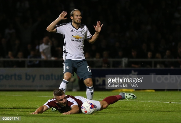 Daley Blind Manchester United puts his hands up after he tackles Northampton Town's Sam Hoskins which leads to a penalty. | Photo: Catherine Ivill - AMA/Getty Images 