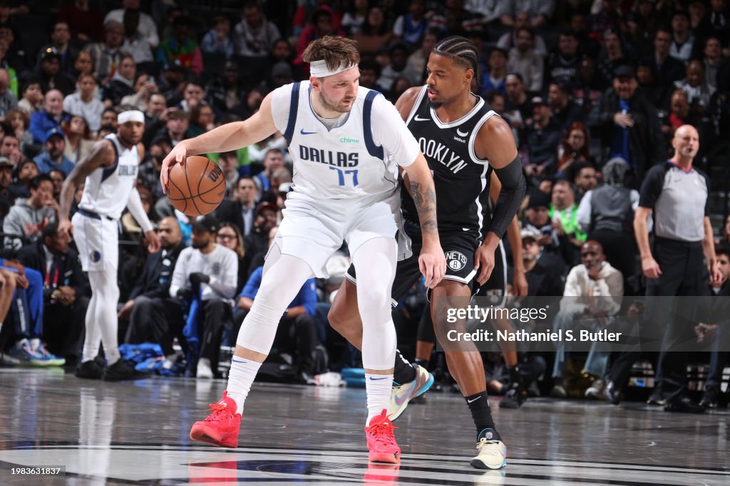 Dennis Smith Jr. #4 of the Brooklyn Nets plays defense during the game against Luka Doncic #77 of the Dallas Mavericks on February 6, 2024 at Barclays Center in Brooklyn, New York. NOTE TO USER: User expressly acknowledges and agrees that, by downloading and or using this Photograph, user is consenting to the terms and conditions of the Getty Images License Agreement. Mandatory Copyright Notice: Copyright 2024 NBAE (Photo by Nathaniel S. Butler/NBAE via Getty Images)