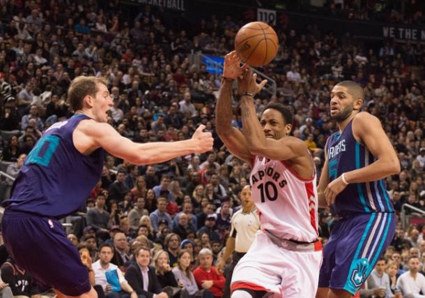 DeMar DeRozan (middle) drives to the rim against Nicolas Batum (right) and Cody Zeller (left). PHOTO: Nick Turchiaro-USA Today  