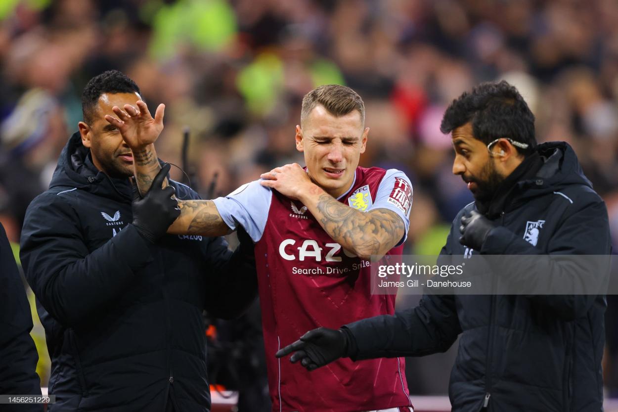Lucas Digne walking off in agony after being injured in the 5th minute. (Photo by James Gill - Danehouse/Getty Images)