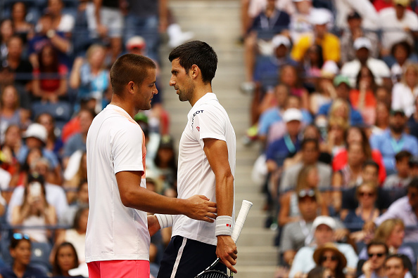 Djokovic and Youzhny following the conclusion of Youzhny's retirement (Photo by Elsa / Getty Images)