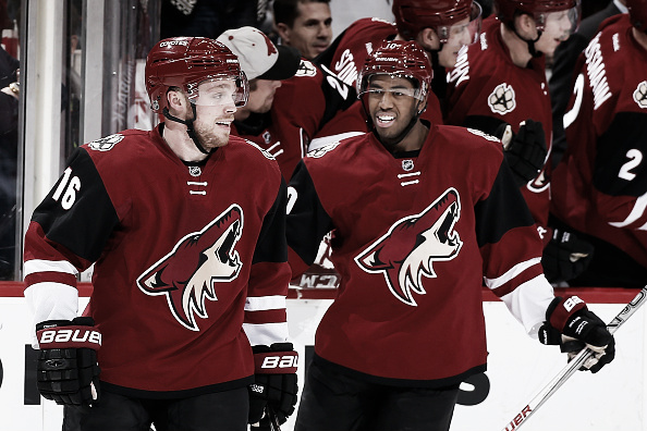  Max Domi #16 and Anthony Duclair #10 of the Arizona Coyotes celebrate after Domi scored a hat trick goal against the Edmonton Oilers during the third period of the NHL game at Gila River Arena on January 12, 2016 in Glendale, Arizona. The Coyotes defeated the Oilers 4-3 in overtime. (Photo by Christian Petersen/Getty Images)