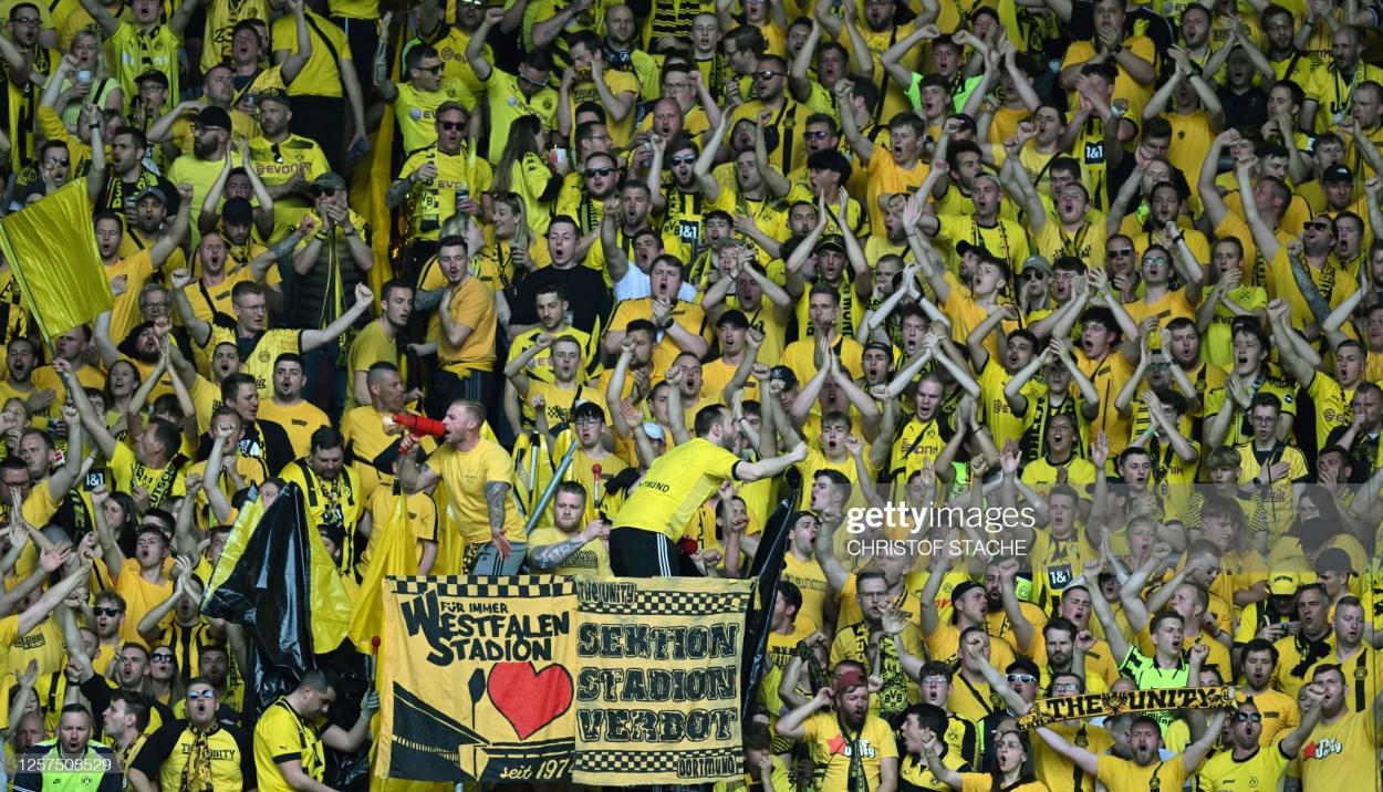 Dortmund's supporters cheer for their team prior to their 3-0 win over FC Augsburg (Photo by Christof STACHE / AFP) 