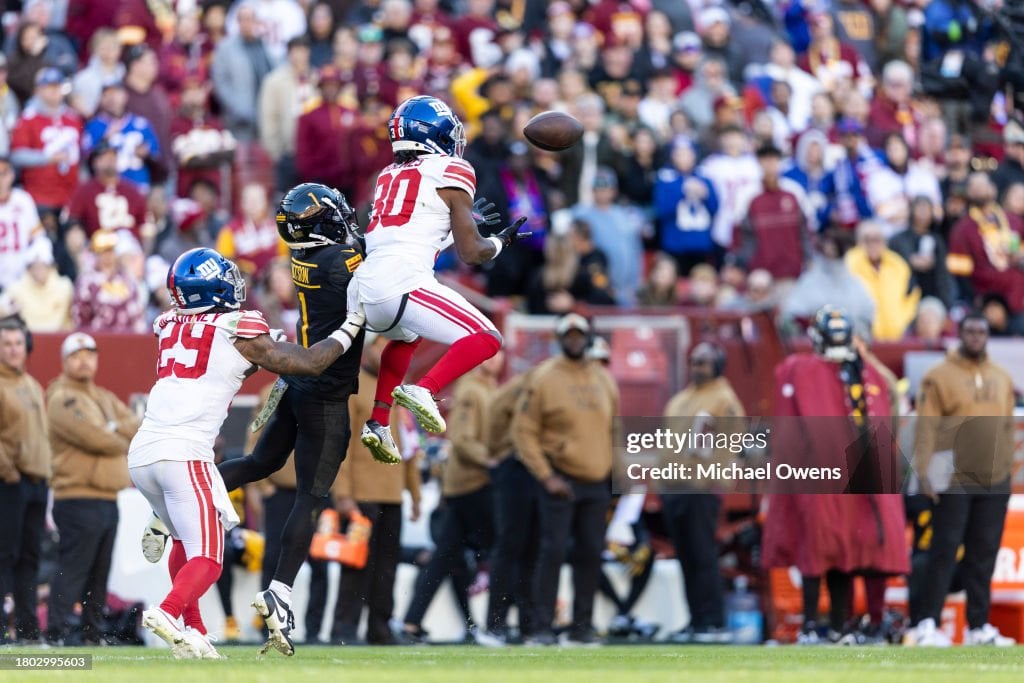 Darnay Holmes #30 of the New York Giants intercepts a pass intended for Jahan Dotson #1 of the Washington Commanders during an NFL football game between the Washington Commanders and the New York Giants at FedExField on November 19, 2023 in Landover, Maryland. (Photo by Michael Owens/Getty Images)
